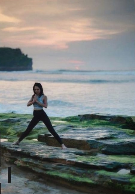 Teacher guiding restful pose